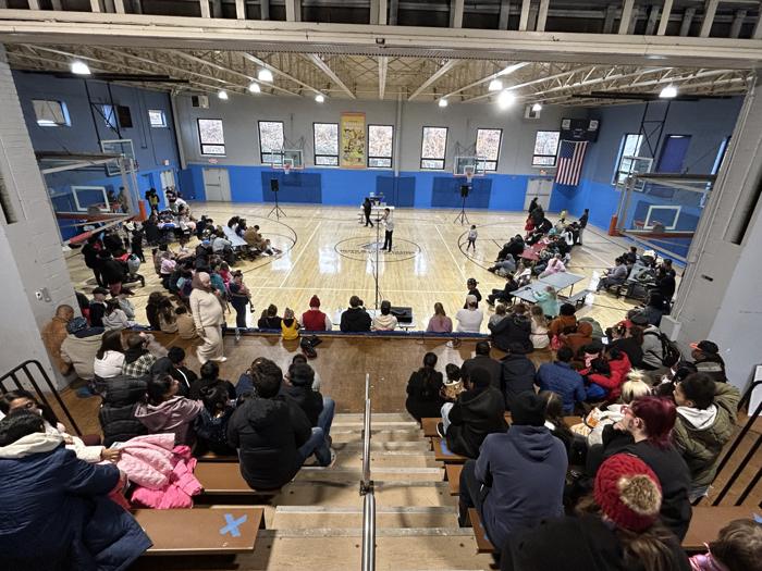 A gym full of families at an indoor outreach