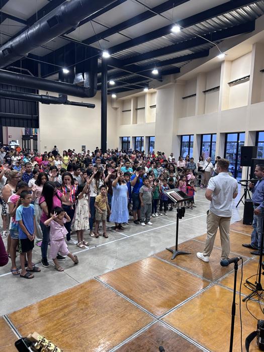 A large hall filled with people at an indoor crusade