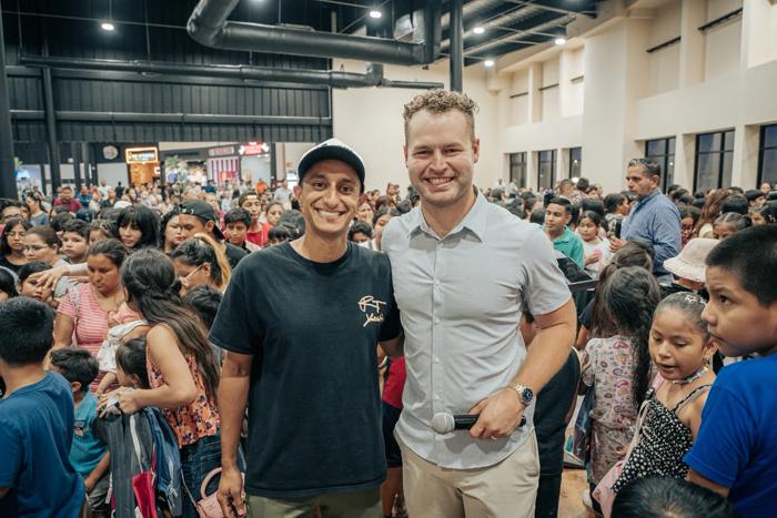 Josh with a guest evangelist in a packed gym