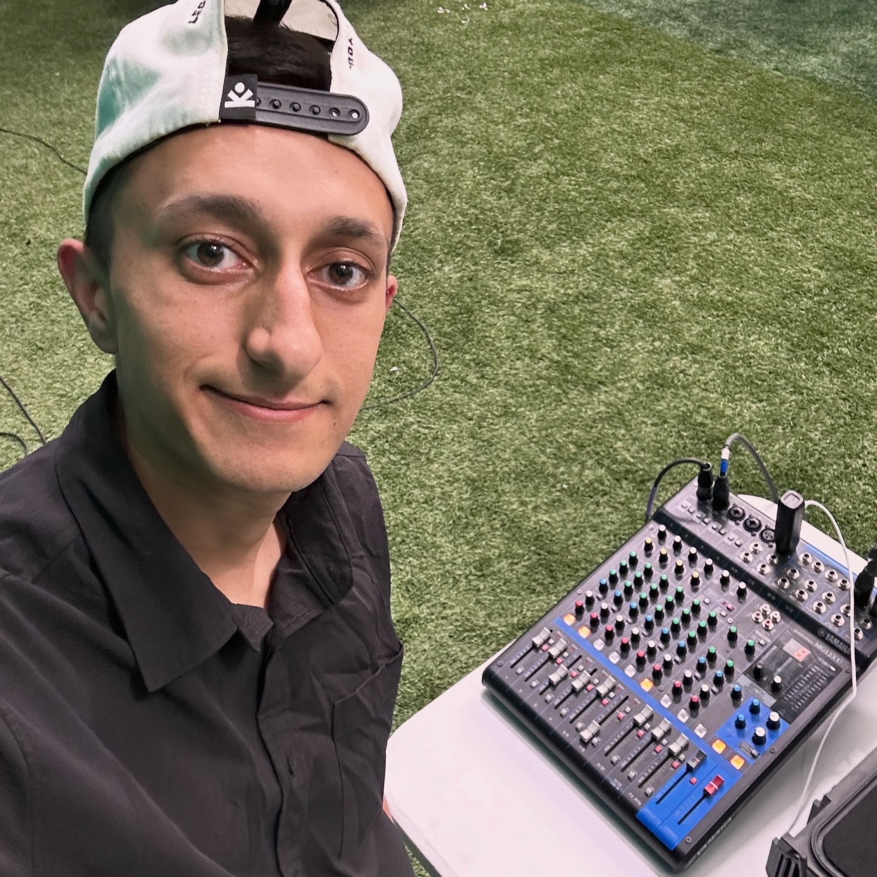 Josh at the sound board during an outreach