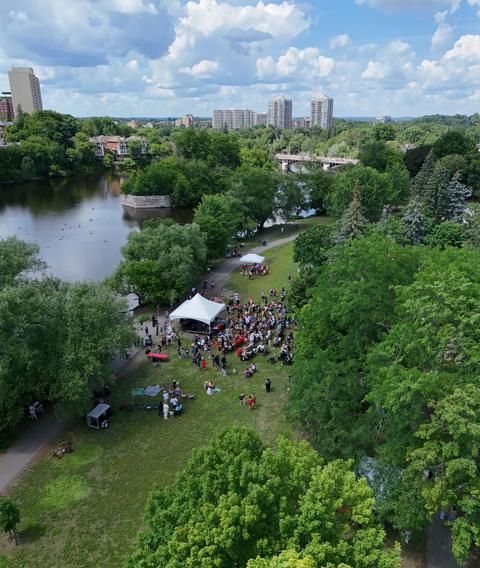 Aerial view of a park outreach with a crowd around the stage