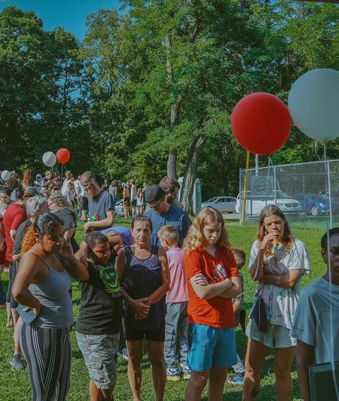 Balloons and a crowd at an outreach