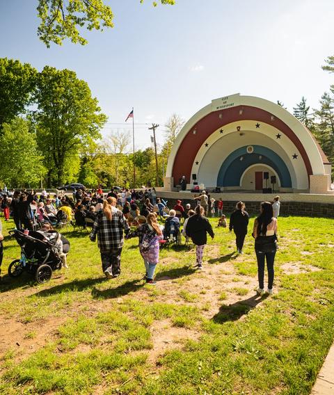 Families gathered in front of a bandshell