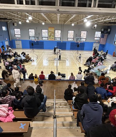 A gym full of families at an indoor outreach