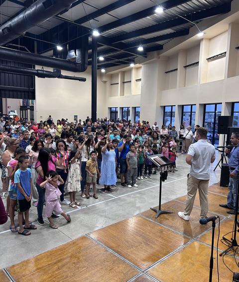 People gathered at the altar during a meeting
