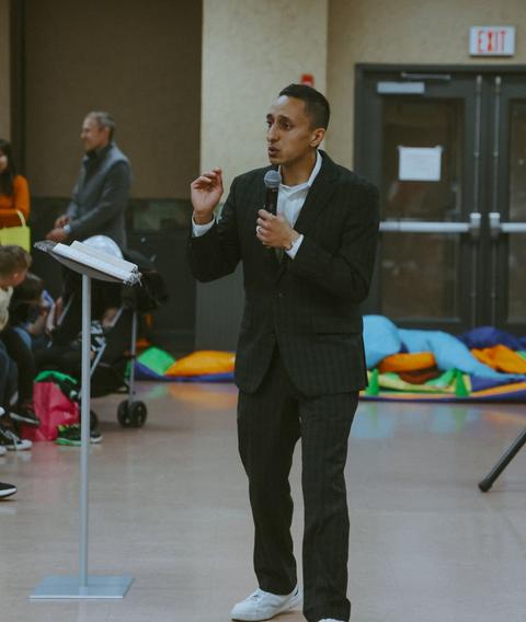 Preaching to a full room at an indoor meeting